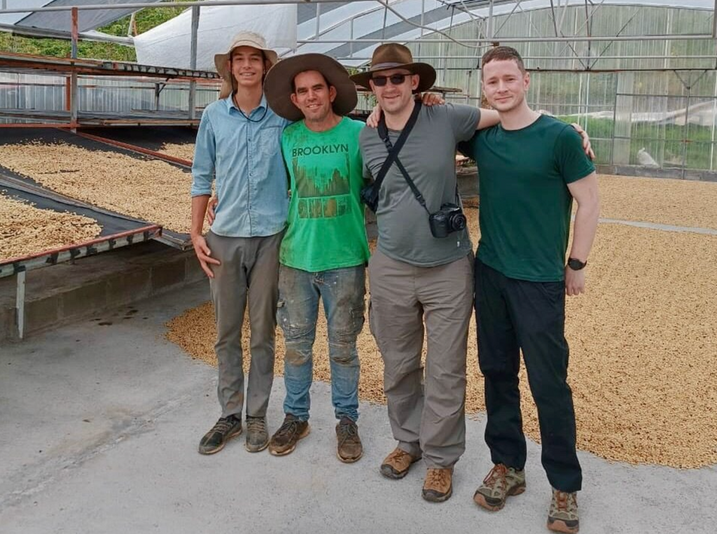 Allan's son Nacho, Allan Oviedo, Ozone Green Buyer Roland Glew, and Ozone Head of eCommerce Chris Price inside the drying area of the Don Joel micromill