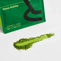 Close-up of Good & Proper House Matcha powder showing fine stone-ground texture.
