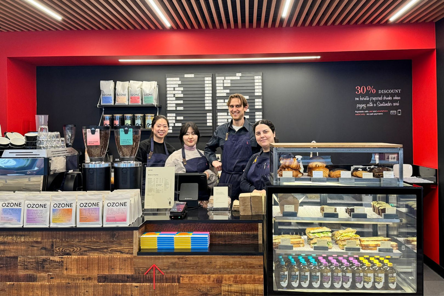 4 baristas at a Santander Work Cafe ready to brew delicious coffee