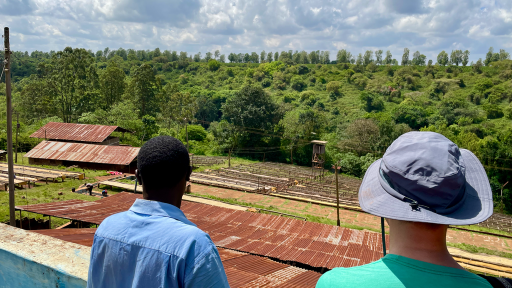 OCR Green Buyer Roland Glew looks over the Kiriga Estate with a farm worker