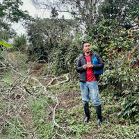 Eyner Saldivar with his coffee trees at El Cedro in Jaen, Peru