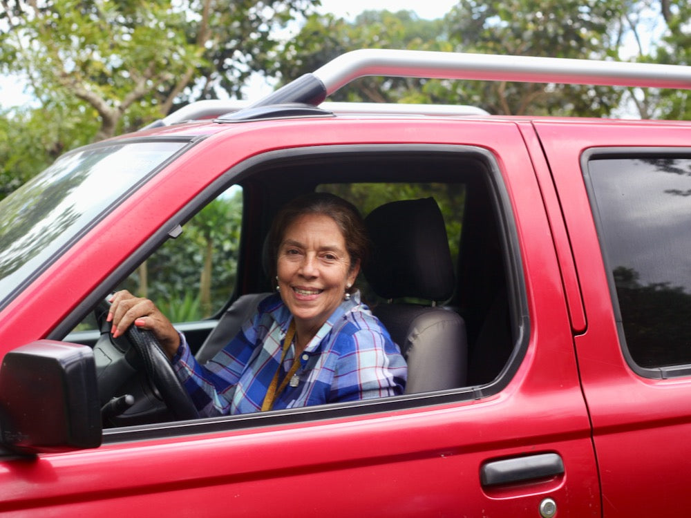 Gloria Rodriguez - Ahuachapán, El Salvador in her red pickup truck arriving at Finca San José in Ahuachapán, 
