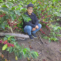 Kevin Guerrero with his coffee at La Esmeralda in Cajamarca, Peru