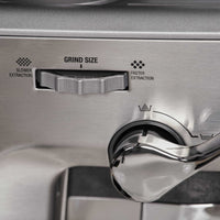 Close-up of Sage Barista Express™ Impress SES876 Home Espresso Machine's grind size adjustment dial with labels.