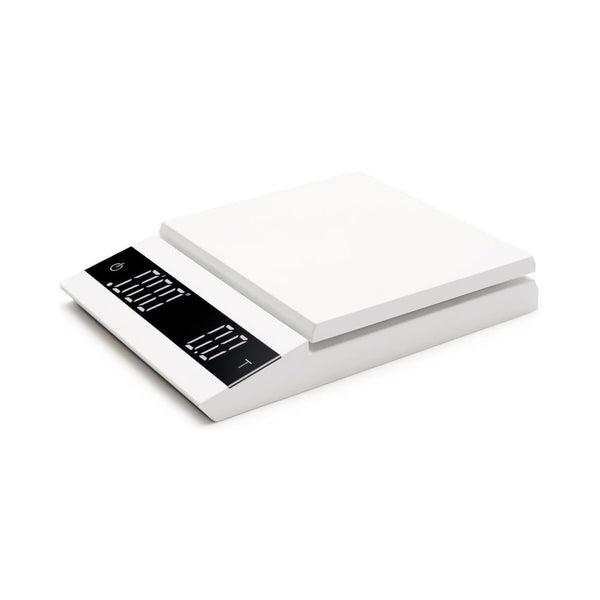 A white, parallel-style coffee scale with a digital display, showing its capacity and a 0.1g measurement marking.
