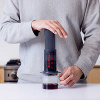 AeroPress brewing coffee into a mug