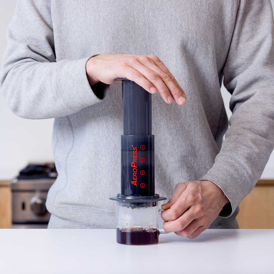 AeroPress brewing coffee into a mug